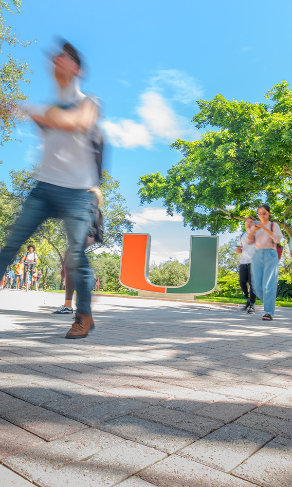 The hustle & bustle of campus captured at the U statue at the Rock.